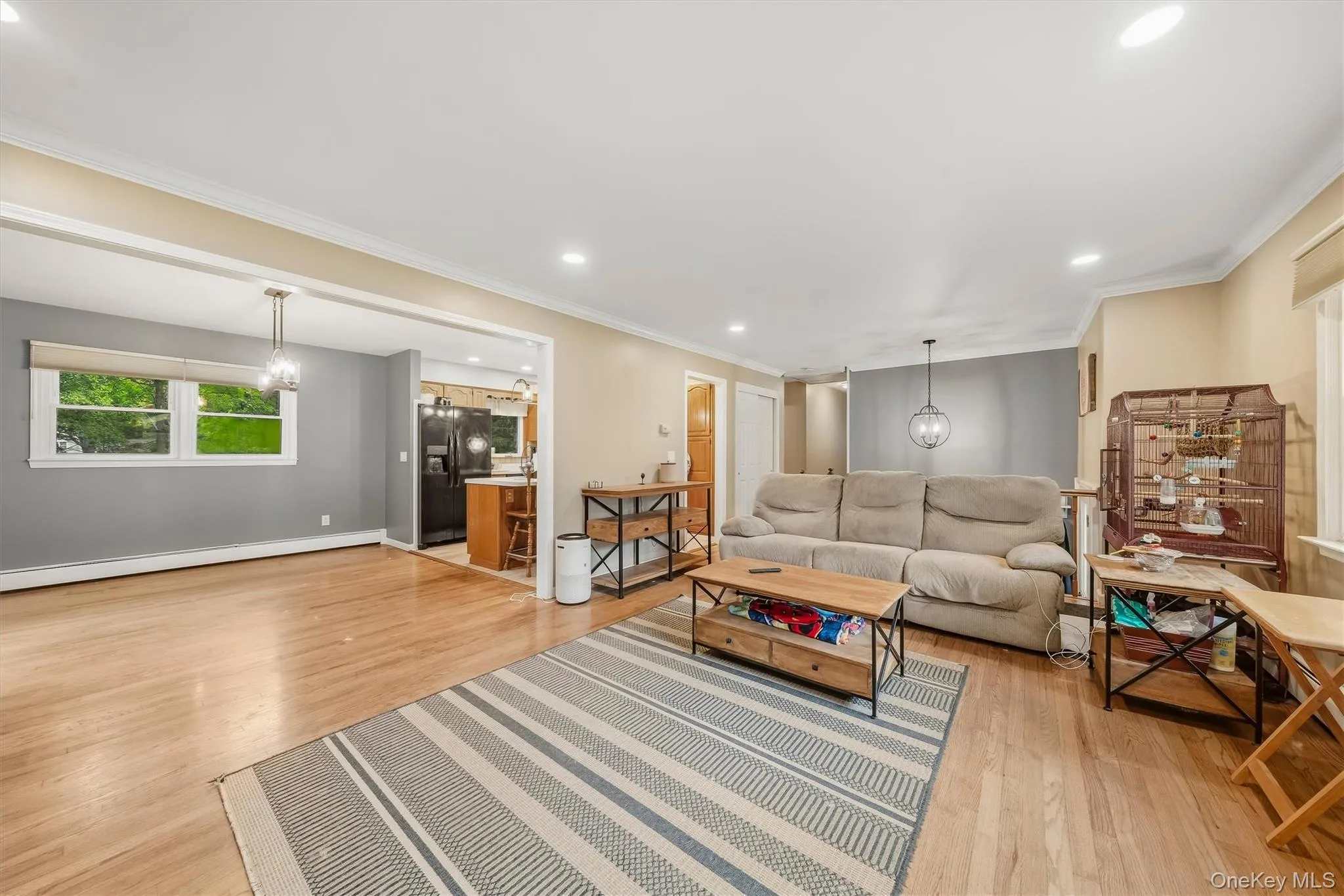 Hardwood-style flooring throughout, recessed lighting, and a pendant light fixture Hardwood-style flooring throughout, recessed lighting, and a pendant light fixture