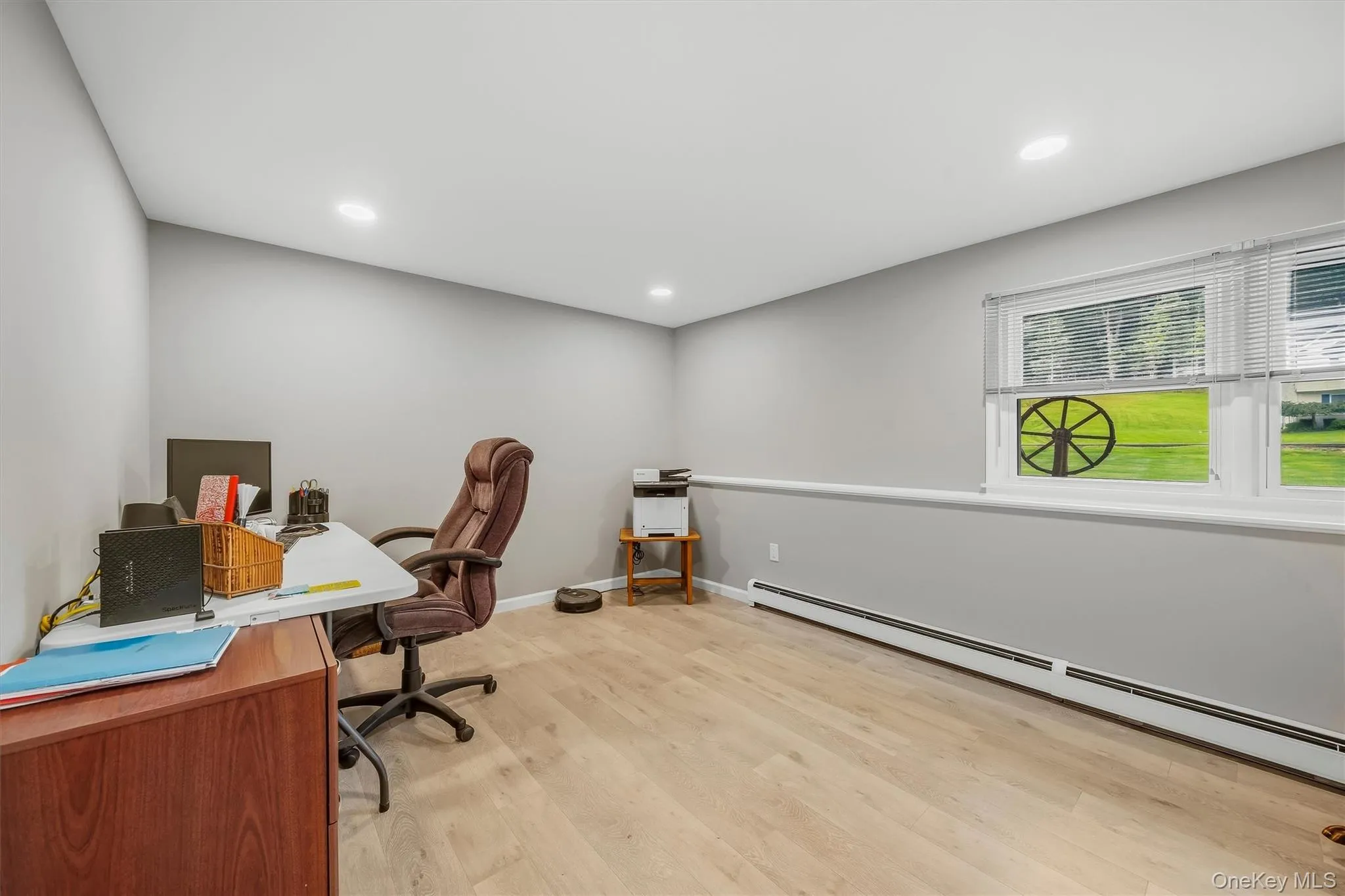 Recessed lighting, light wood-finish flooring, and a window with horizontal blinds Recessed lighting, light wood-finish flooring, and a window with horizontal blinds