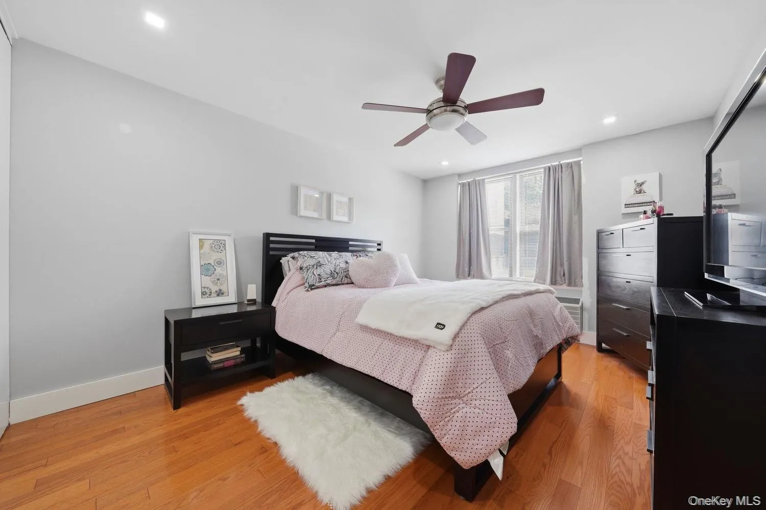 Wood-finish flooring, recessed lighting, and a ceiling fan with light fixture Wood-finish flooring, recessed lighting, and a ceiling fan with light fixture