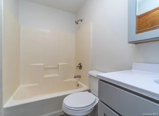 Bathtub with integrated shower, wall-mounted showerhead, and toilet Bathtub with integrated shower, wall-mounted showerhead, and toilet