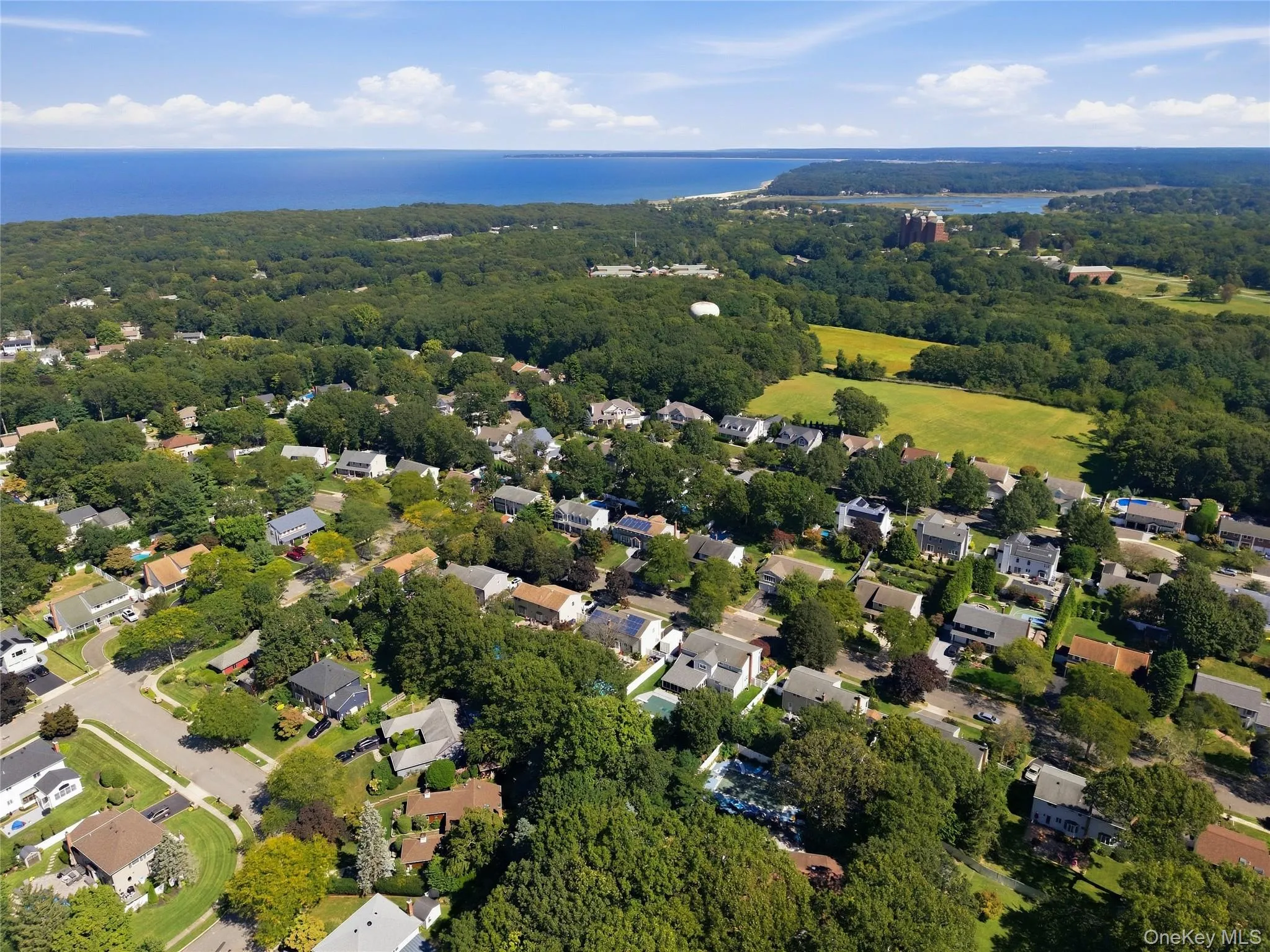 Residential area with lush tree coverage and coastal proximity Residential area with lush tree coverage and coastal proximity