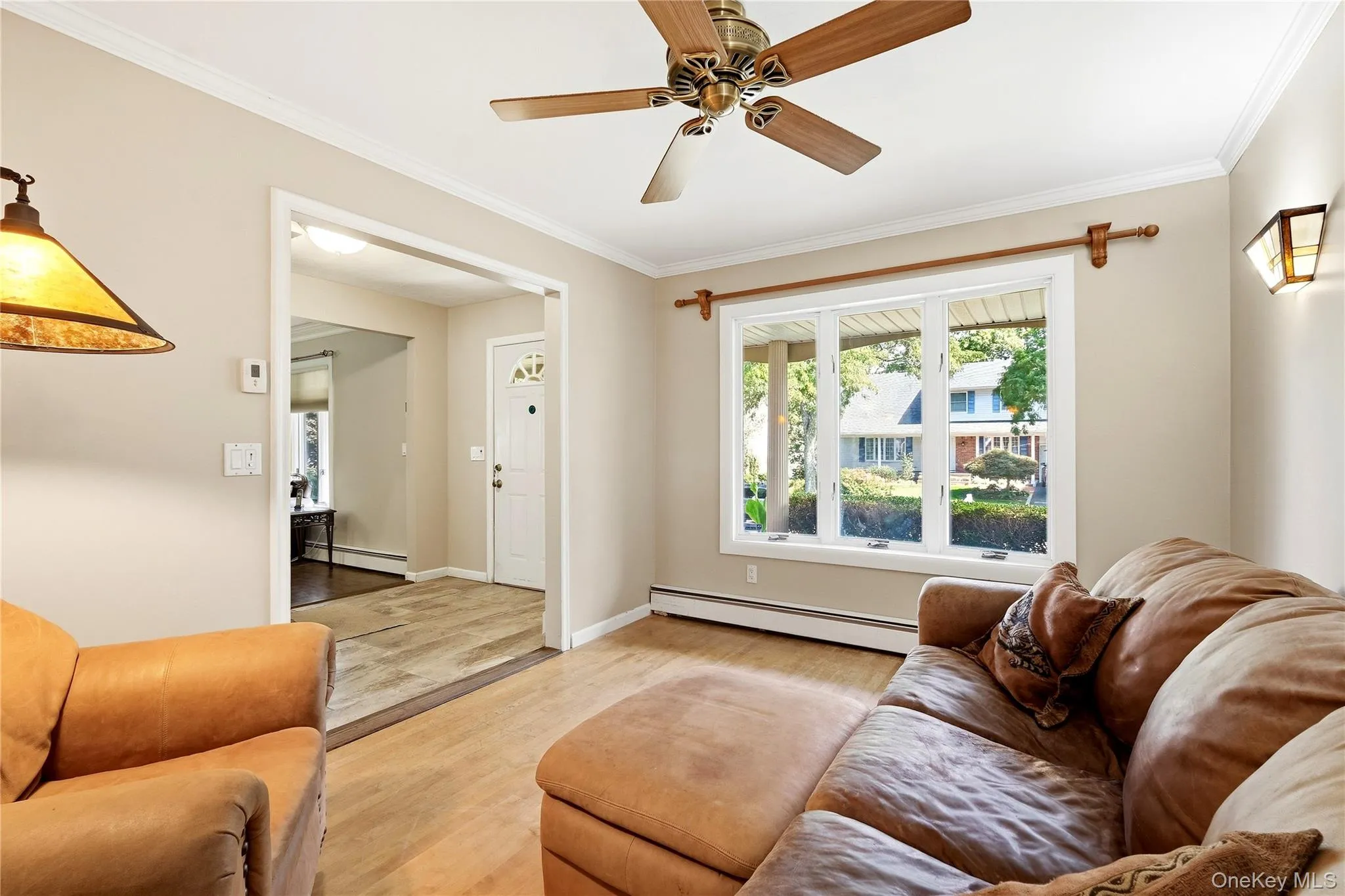 Crown molding accenting the ceiling, and hardwood flooring. This room can also serve as a dining room Crown molding accenting the ceiling, and hardwood flooring. This room can also serve as a dining room