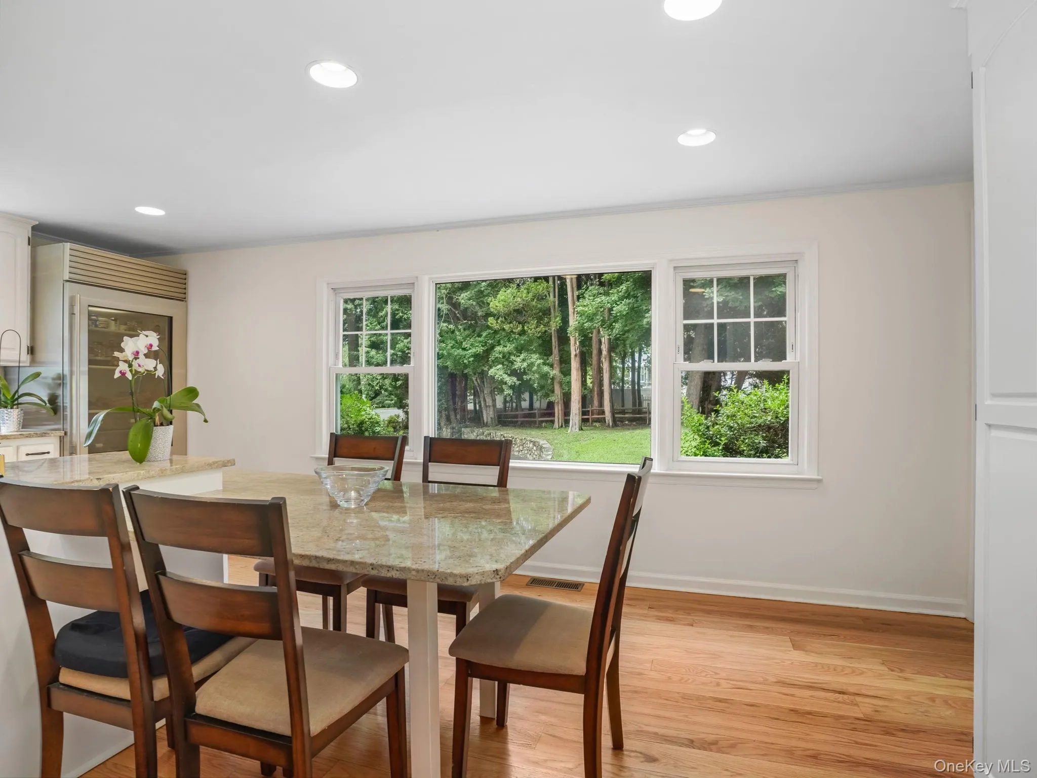 Dining area with light wood-type flooring and recessed lighting Dining area with light wood-type flooring and recessed lighting