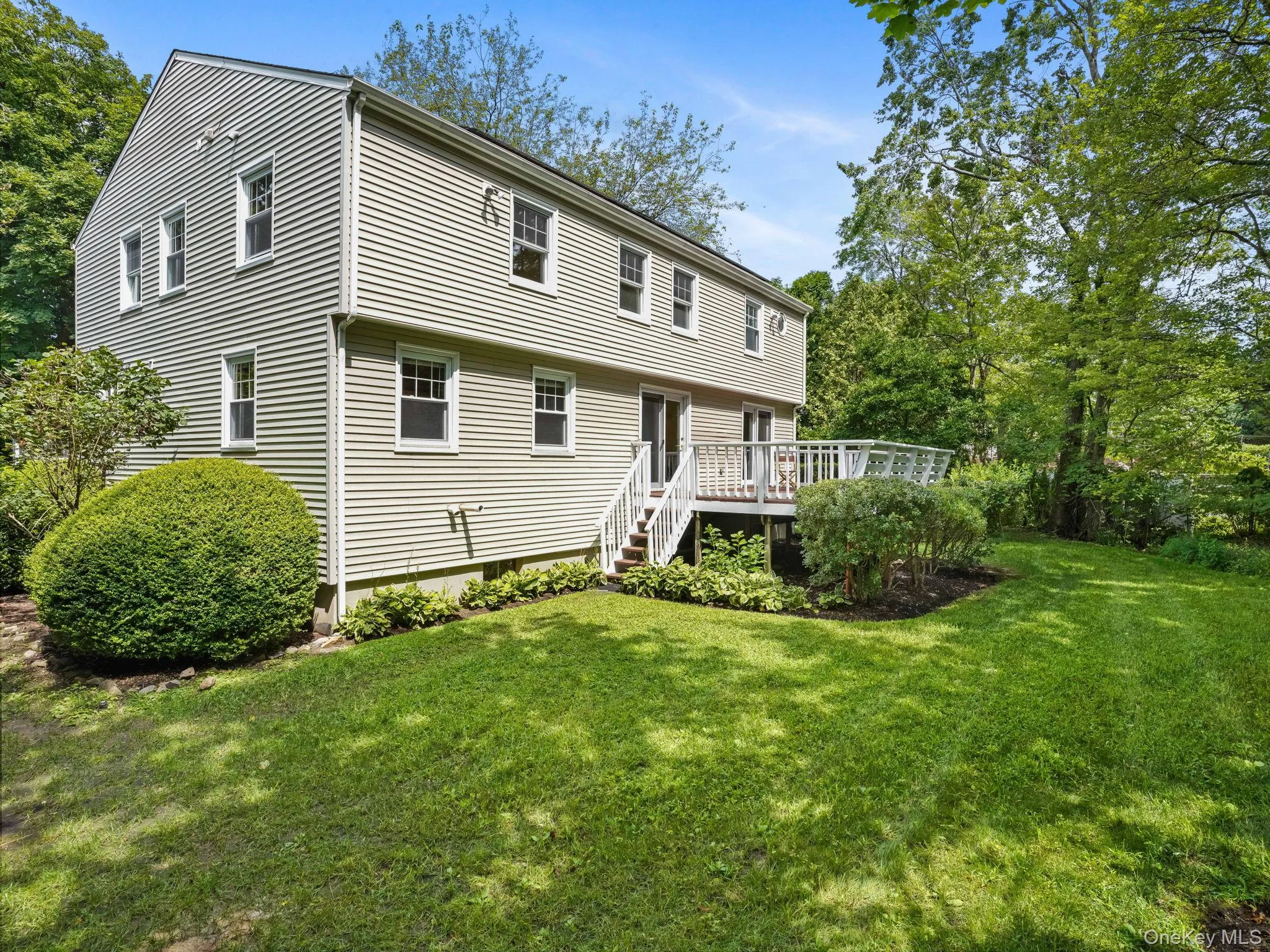 Back of property with a deck and a yard Back of property with a deck and a yard