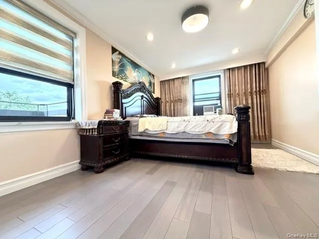 Light wood-finish flooring with recessed lighting and a semi-flush mount fixture Light wood-finish flooring with recessed lighting and a semi-flush mount fixture