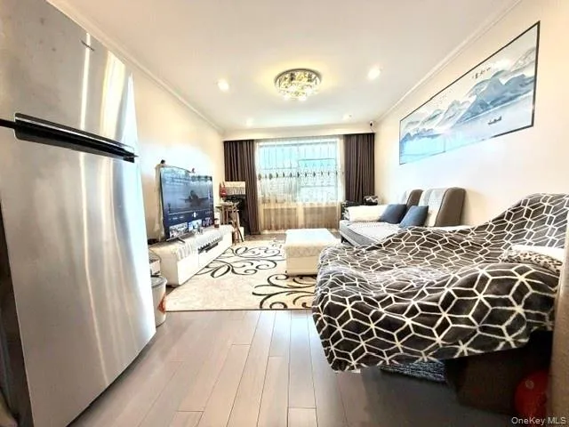 Recessed lighting, wood-finish flooring, stainless steel refrigerator, window with blinds, and decorative overhead light fixture Recessed lighting, wood-finish flooring, stainless steel refrigerator, window with blinds, and decorative overhead light fixture