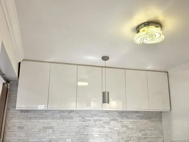 White high-gloss cabinetry with a sleek finish White high-gloss cabinetry with a sleek finish