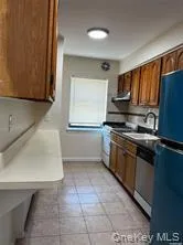 Kitchen featuring dishwasher, sink, refrigerator, white range, and range hood Kitchen featuring dishwasher, sink, refrigerator, white range, and range hood