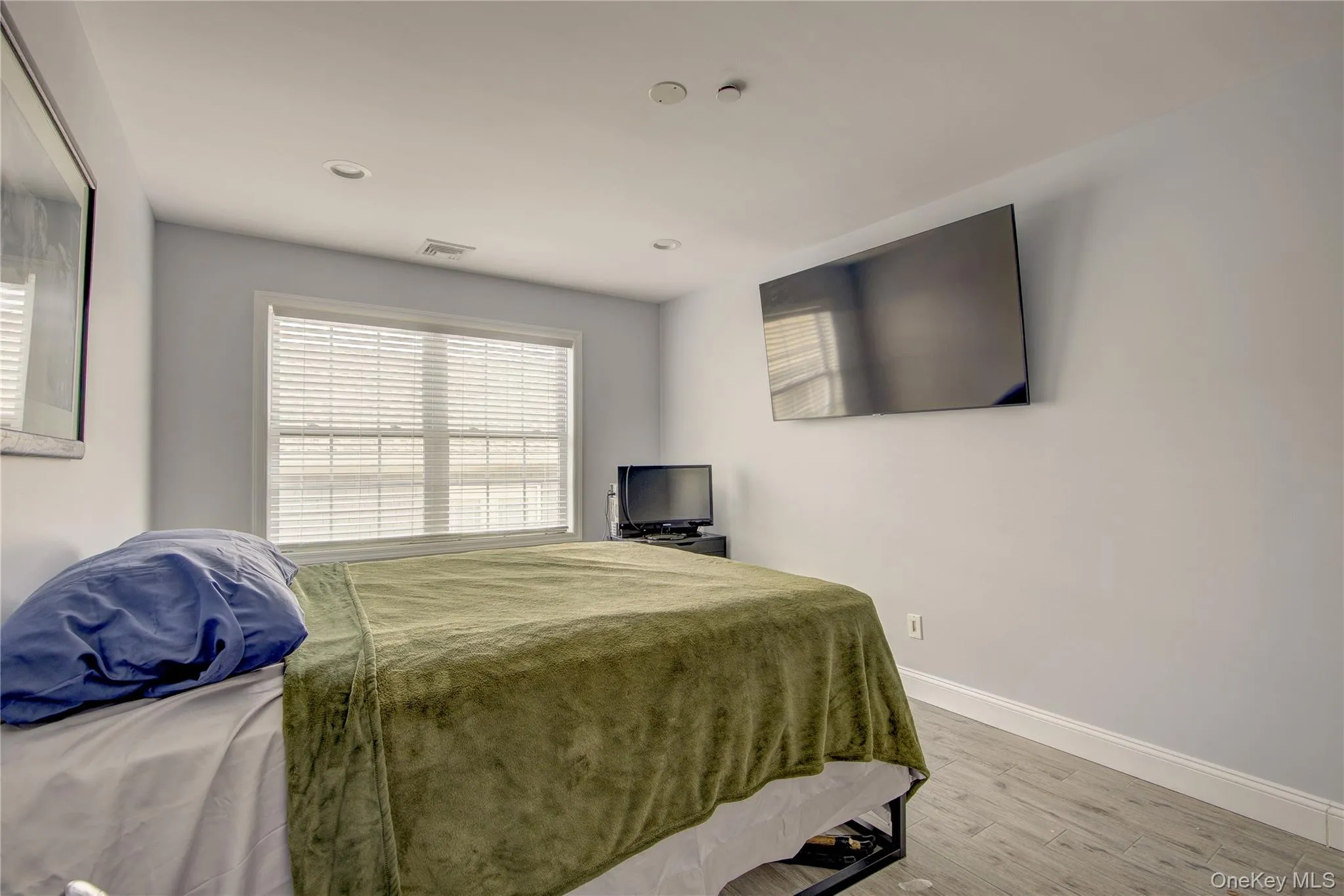 Bedroom with wood finished floors and recessed lighting Bedroom with wood finished floors and recessed lighting
