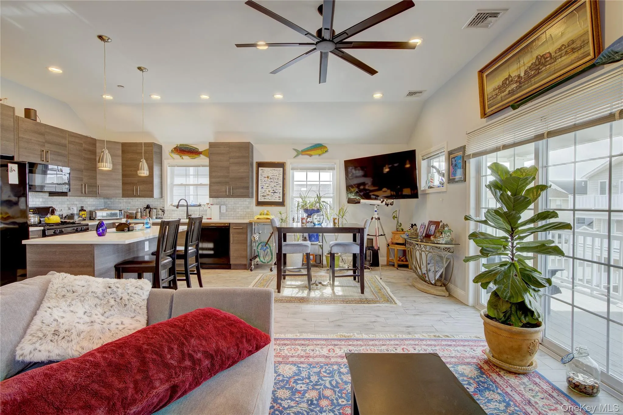 Living room with vaulted ceiling, recessed lighting, light wood-style flooring, and ceiling fan Living room with vaulted ceiling, recessed lighting, light wood-style flooring, and ceiling fan