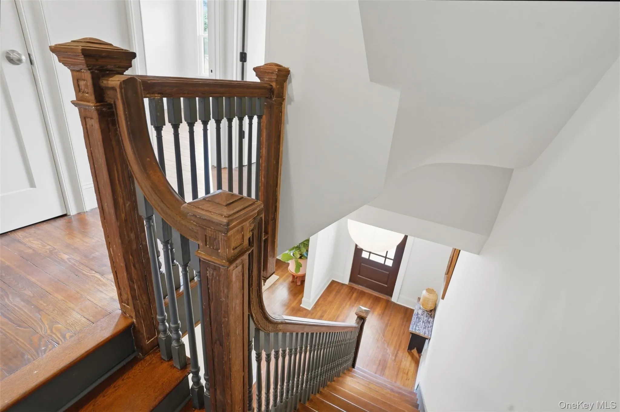 Hardwood flooring, wood newel posts, and dark balusters accent the staircase Hardwood flooring, wood newel posts, and dark balusters accent the staircase