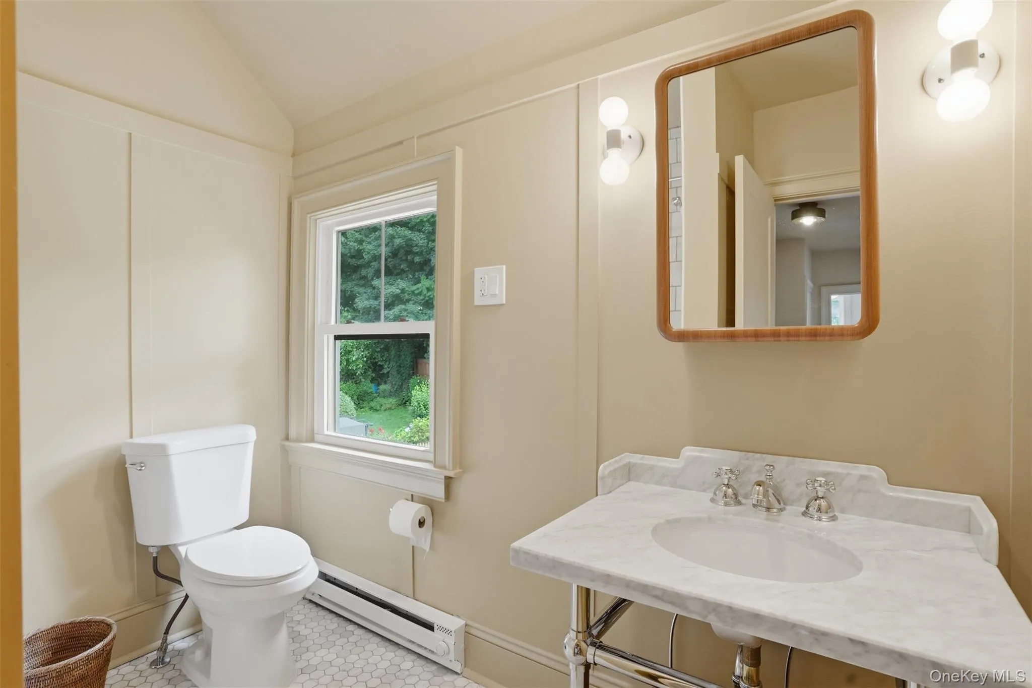 Pedestal vanity featuring a white marble countertop and integrated basin Pedestal vanity featuring a white marble countertop and integrated basin