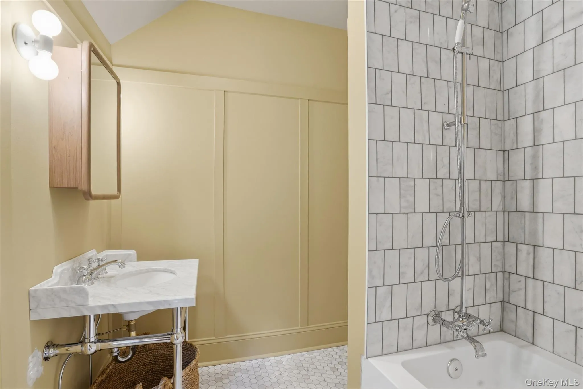 Corner vanity with a marble top, chrome fixtures, and wood-finish medicine cabinet Corner vanity with a marble top, chrome fixtures, and wood-finish medicine cabinet