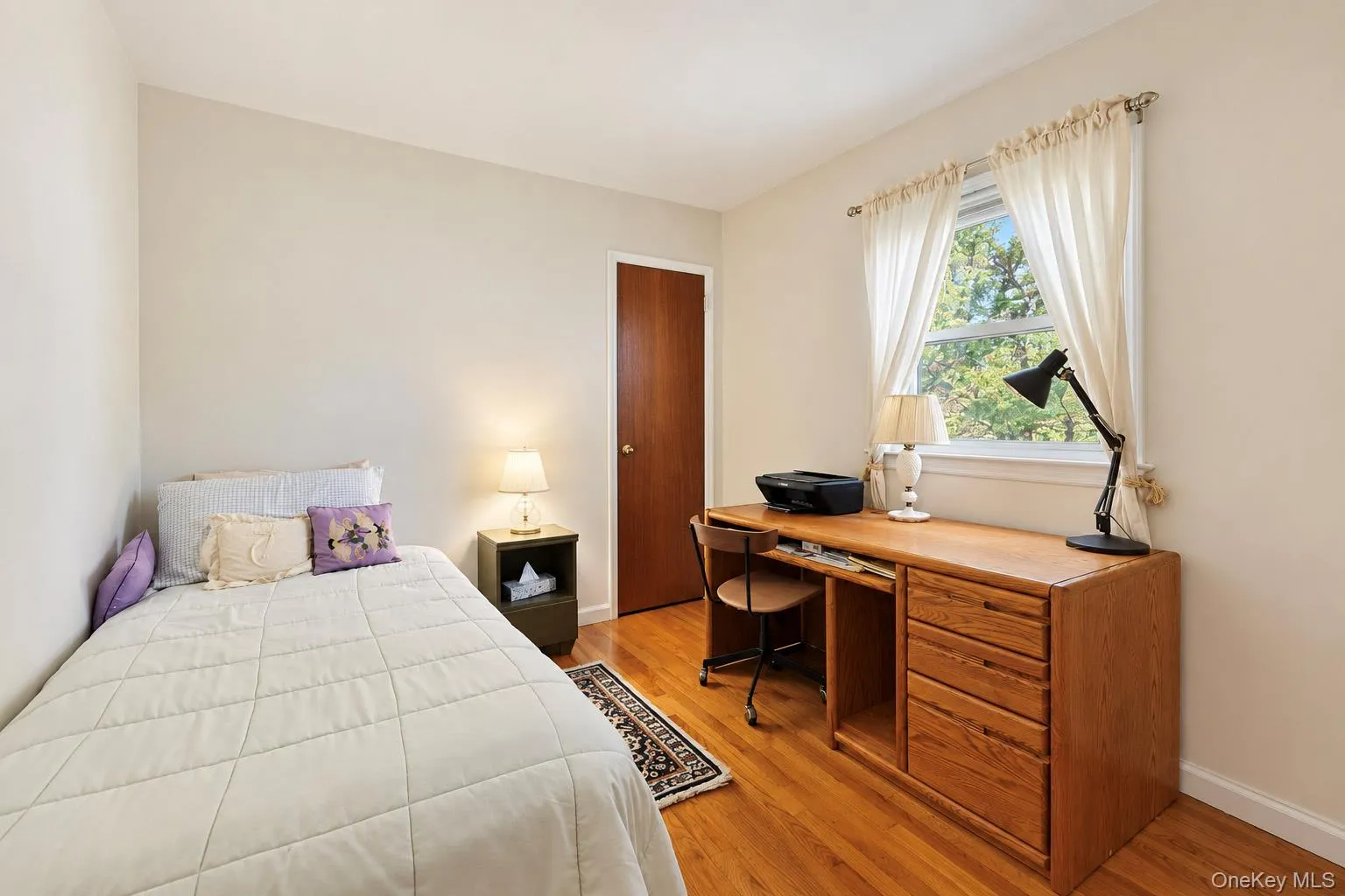 Hardwood flooring, painted walls, window with natural light, and a solid core door Hardwood flooring, painted walls, window with natural light, and a solid core door