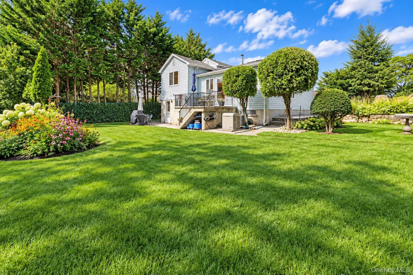 Expansive lawn with established landscaping and mature perimeter trees Expansive lawn with established landscaping and mature perimeter trees