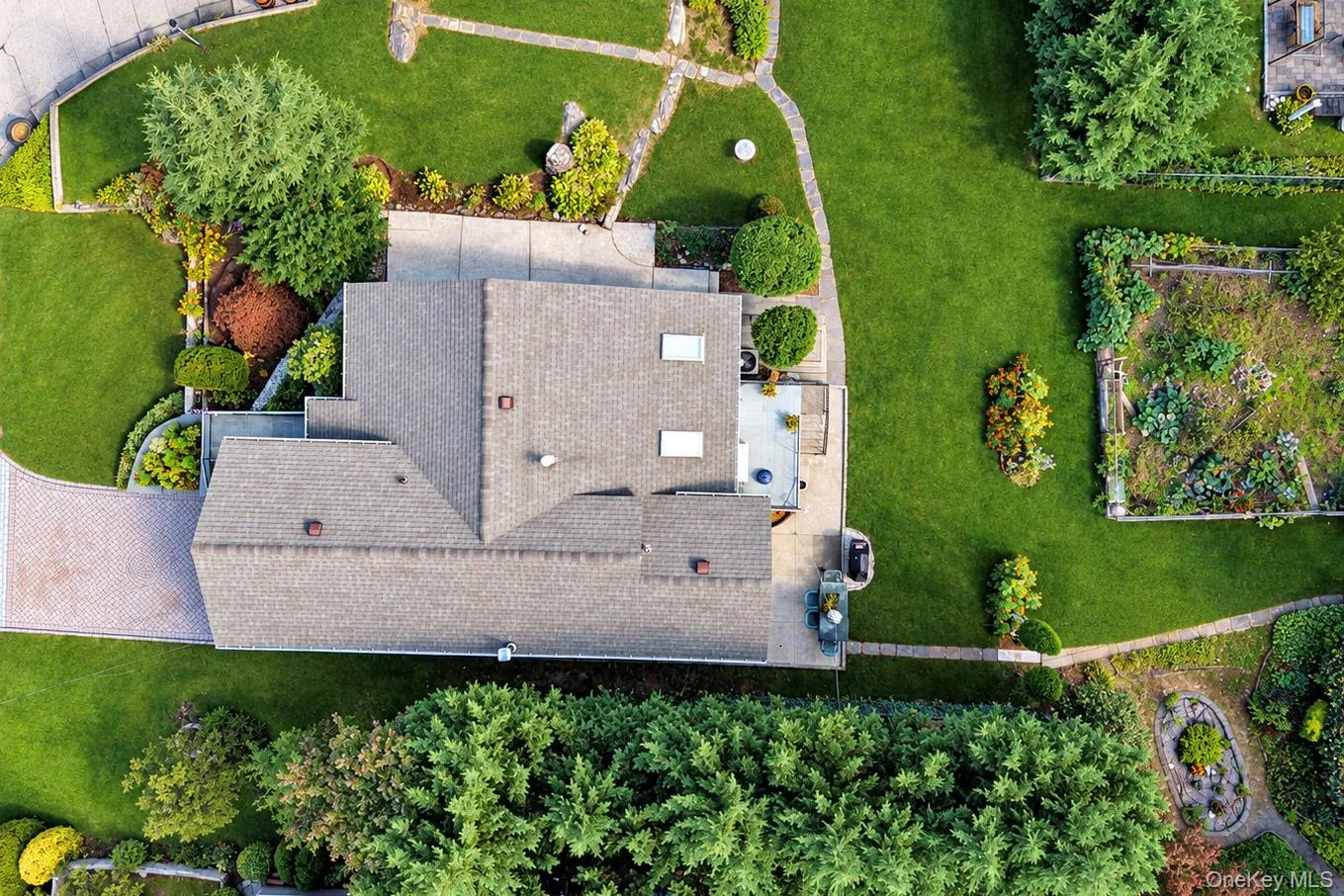 Expansive green lawn, mature trees, paved driveway, patio area, and garden beds Expansive green lawn, mature trees, paved driveway, patio area, and garden beds