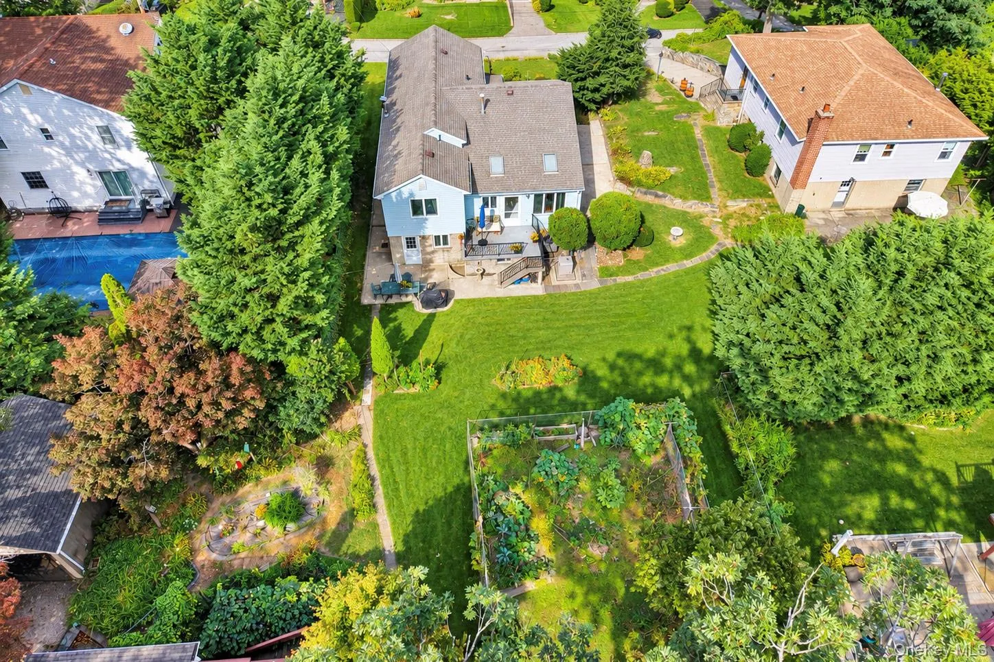 Expansive green lawn with mature landscaping and established garden beds Expansive green lawn with mature landscaping and established garden beds