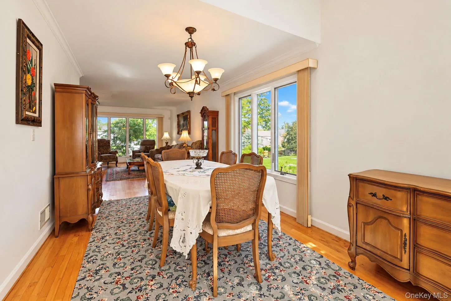 Hardwood flooring, crown molding, large window, chandelier, and a spacious layout Hardwood flooring, crown molding, large window, chandelier, and a spacious layout