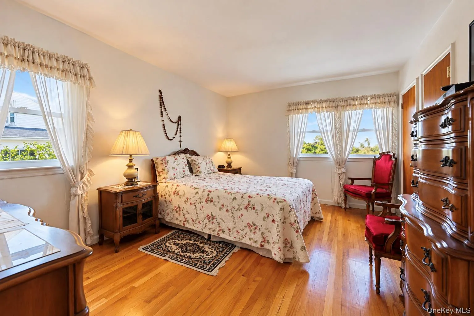 Hardwood flooring, white walls, and multiple windows with white trim Hardwood flooring, white walls, and multiple windows with white trim