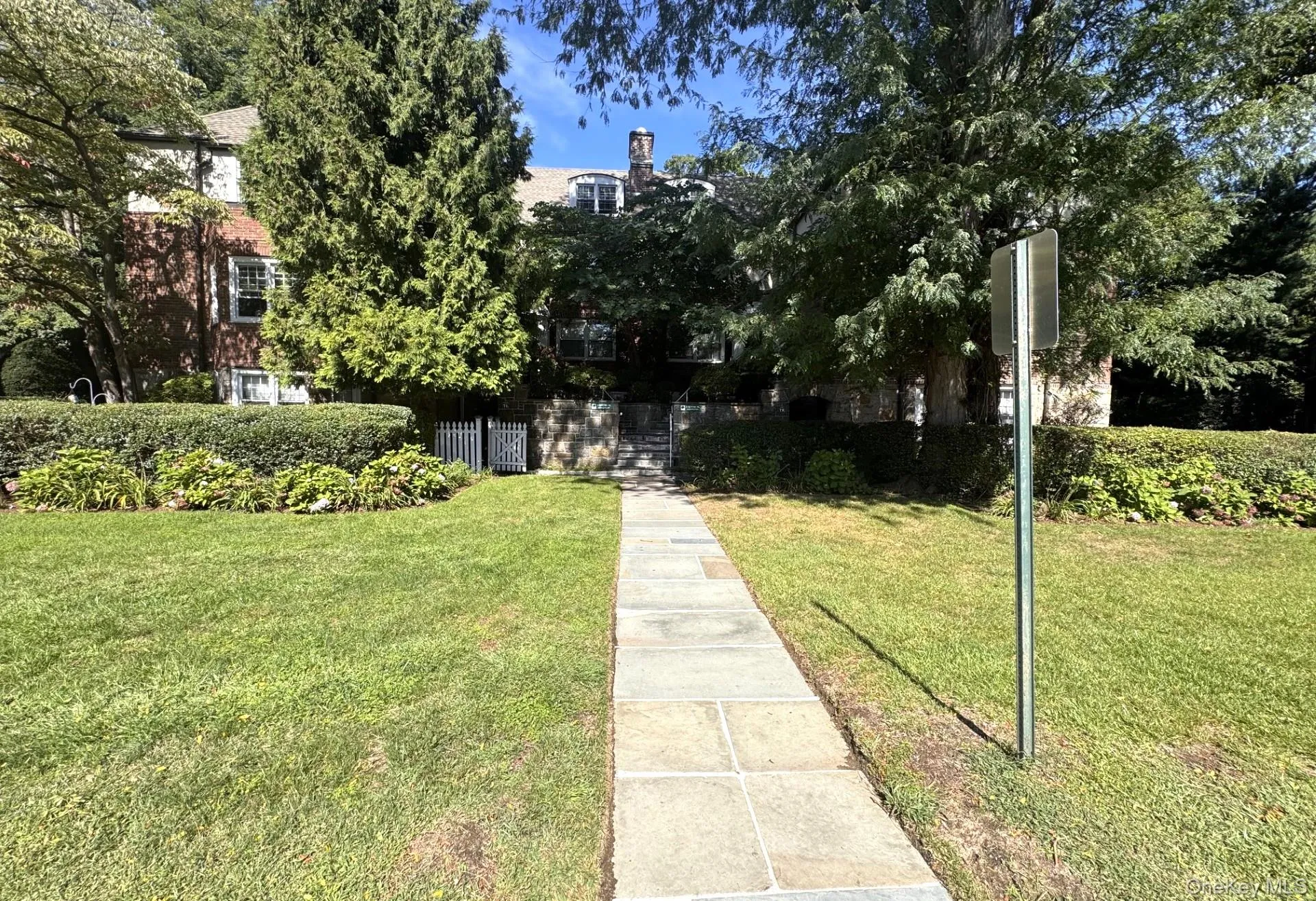 Stone pathway leading to a brick-clad building. Stone pathway leading to a brick-clad building.