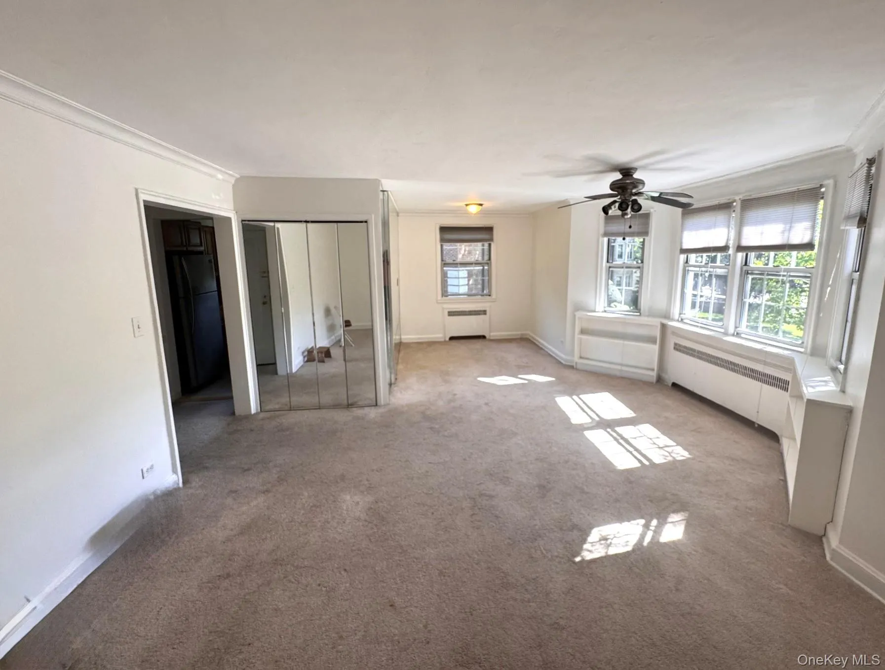 Mirrored closet doors, ceiling fan, multiple windows with blinds, built-in shelving. Mirrored closet doors, ceiling fan, multiple windows with blinds, built-in shelving.