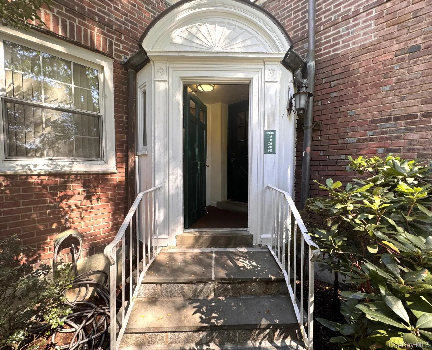 Brick facade with stone steps, and a decorative arched entryway. Brick facade with stone steps, and a decorative arched entryway.