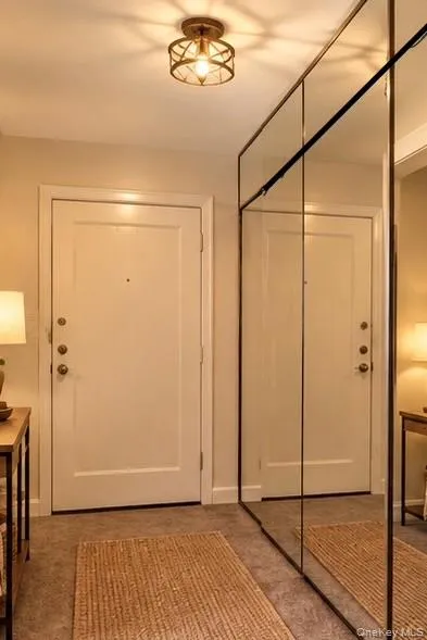 Virtually Staged- Entry way with full-height mirrored front closet near entry door. Virtually Staged- Entry way with full-height mirrored front closet near entry door.