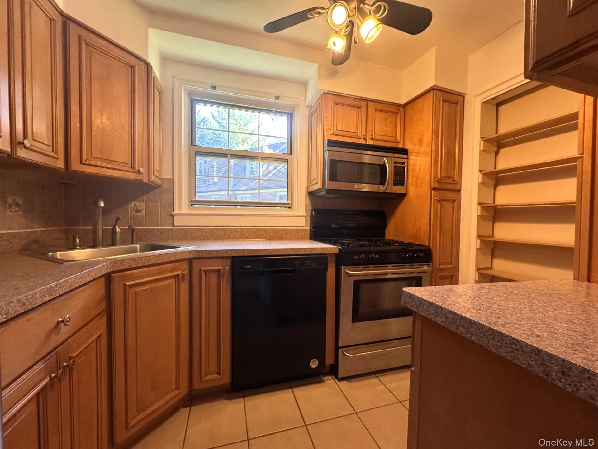 Kitchen featuring warm wood cabinetry, stainless steel appliances, and lots of cabinets. Kitchen featuring warm wood cabinetry, stainless steel appliances, and lots of cabinets.
