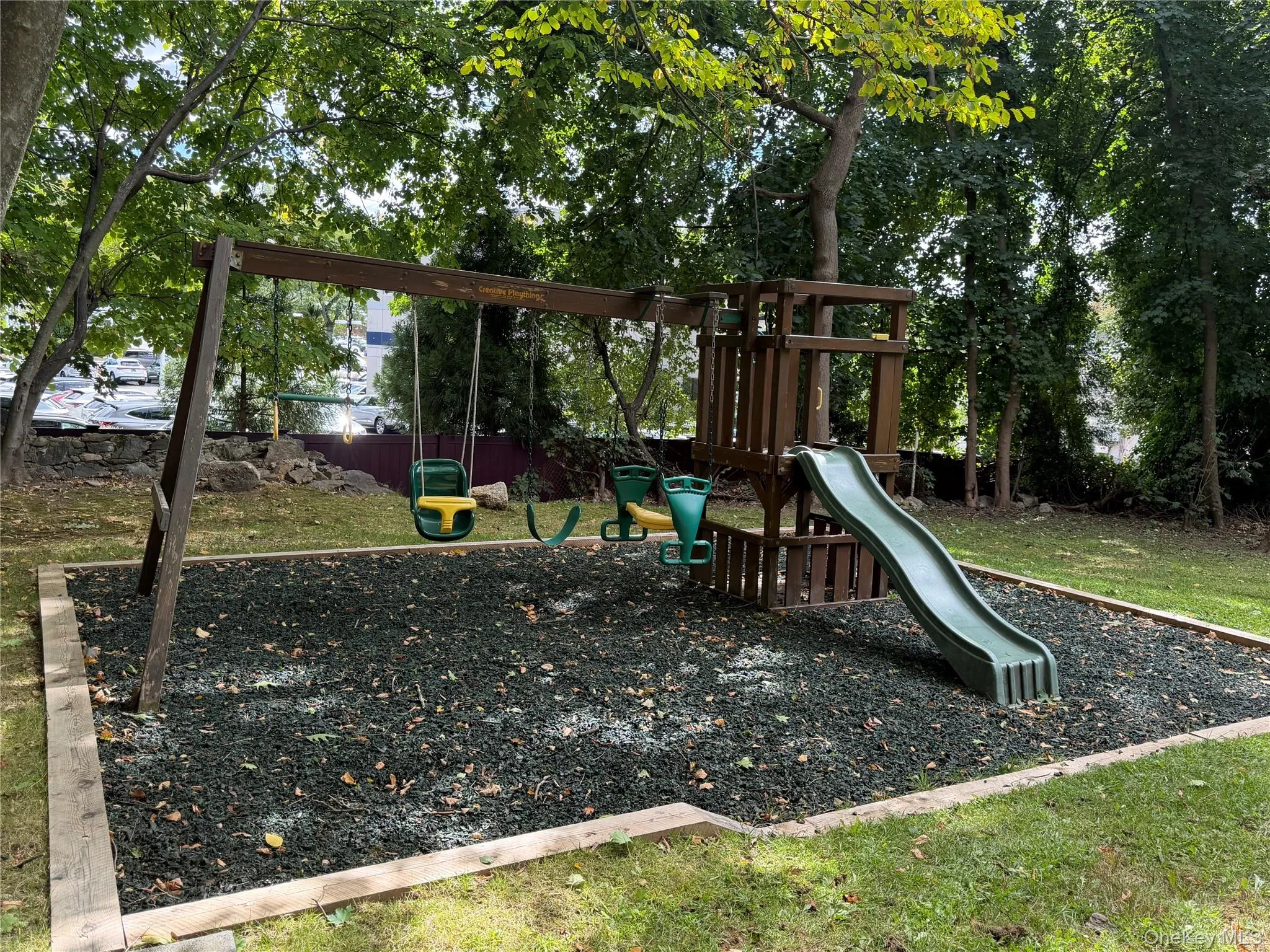 Playground surrounded by trees . Playground surrounded by trees .
