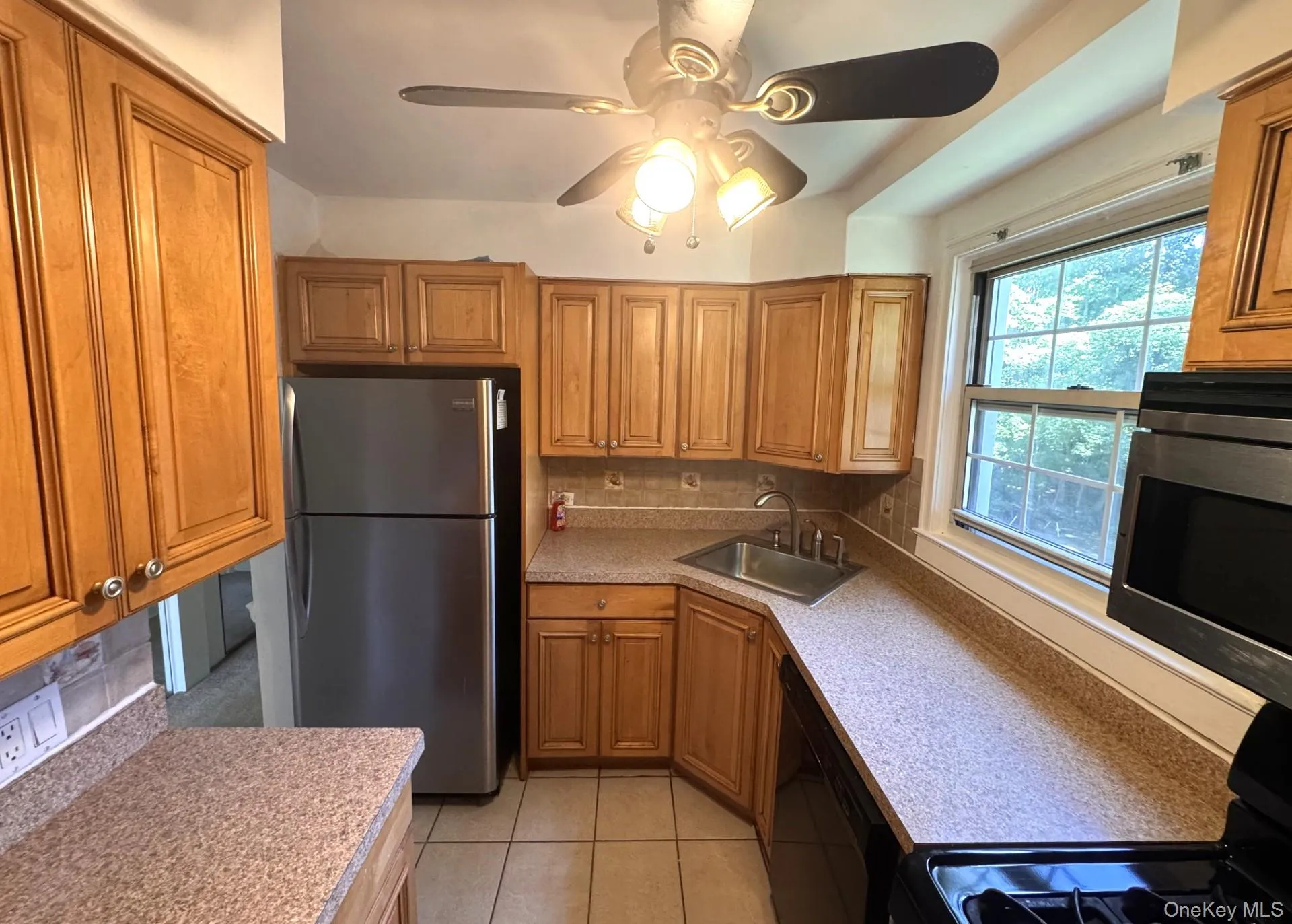Kitchen featuring warm wood cabinetry, stainless steel appliances, and lots of cabinets. Kitchen featuring warm wood cabinetry, stainless steel appliances, and lots of cabinets.