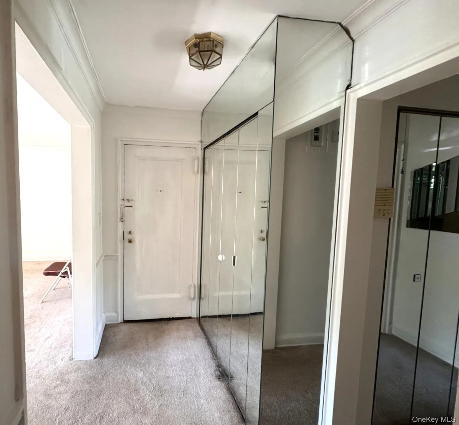 Entry way with full-height mirrored front closet near entry door. Entry way with full-height mirrored front closet near entry door.