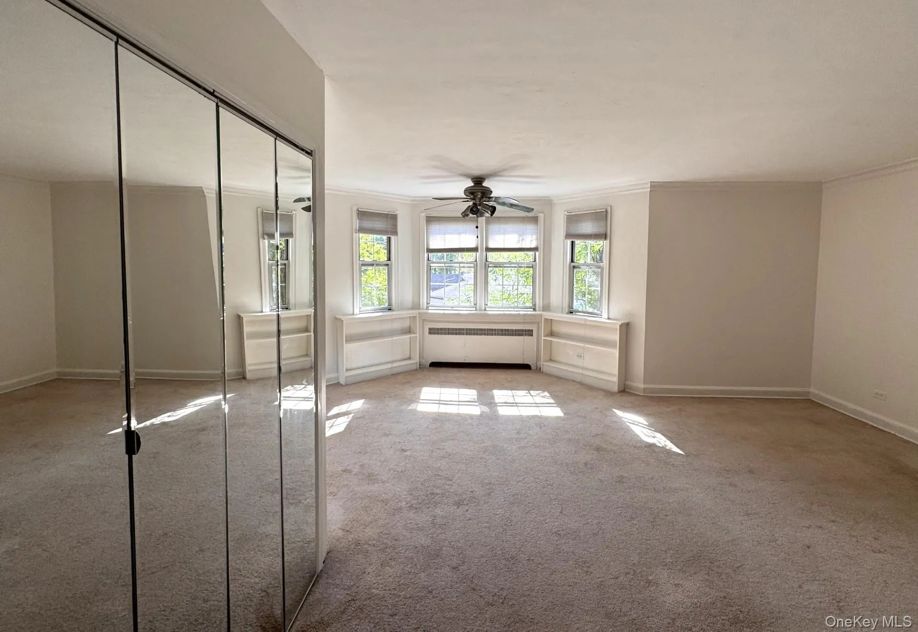 Mirrored closet doors, ceiling fan, multiple windows with blinds, built-in shelving. Mirrored closet doors, ceiling fan, multiple windows with blinds, built-in shelving.