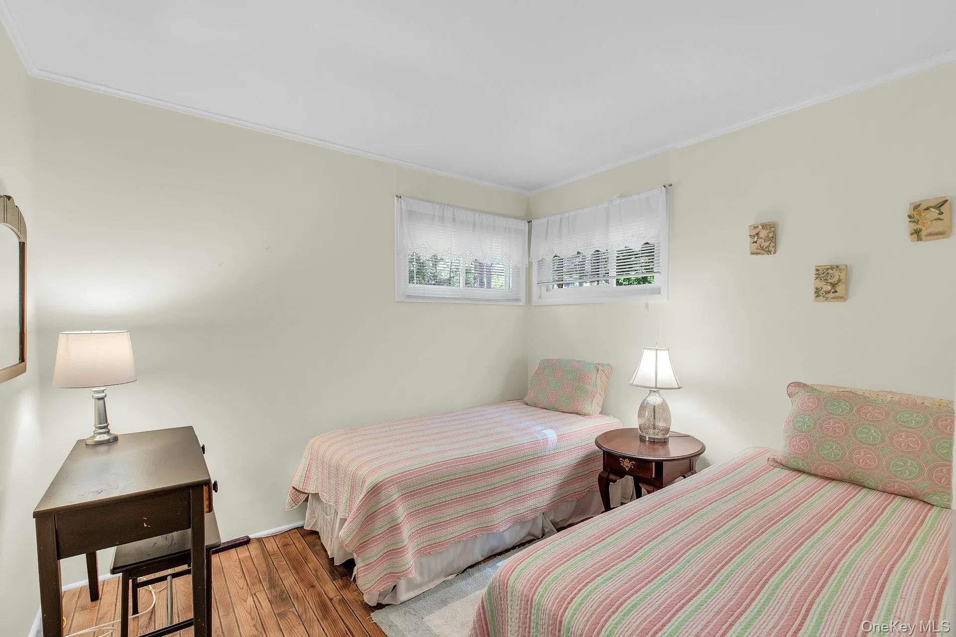 Hardwood flooring, crown molding, double windows, and light-toned wall finishes Hardwood flooring, crown molding, double windows, and light-toned wall finishes