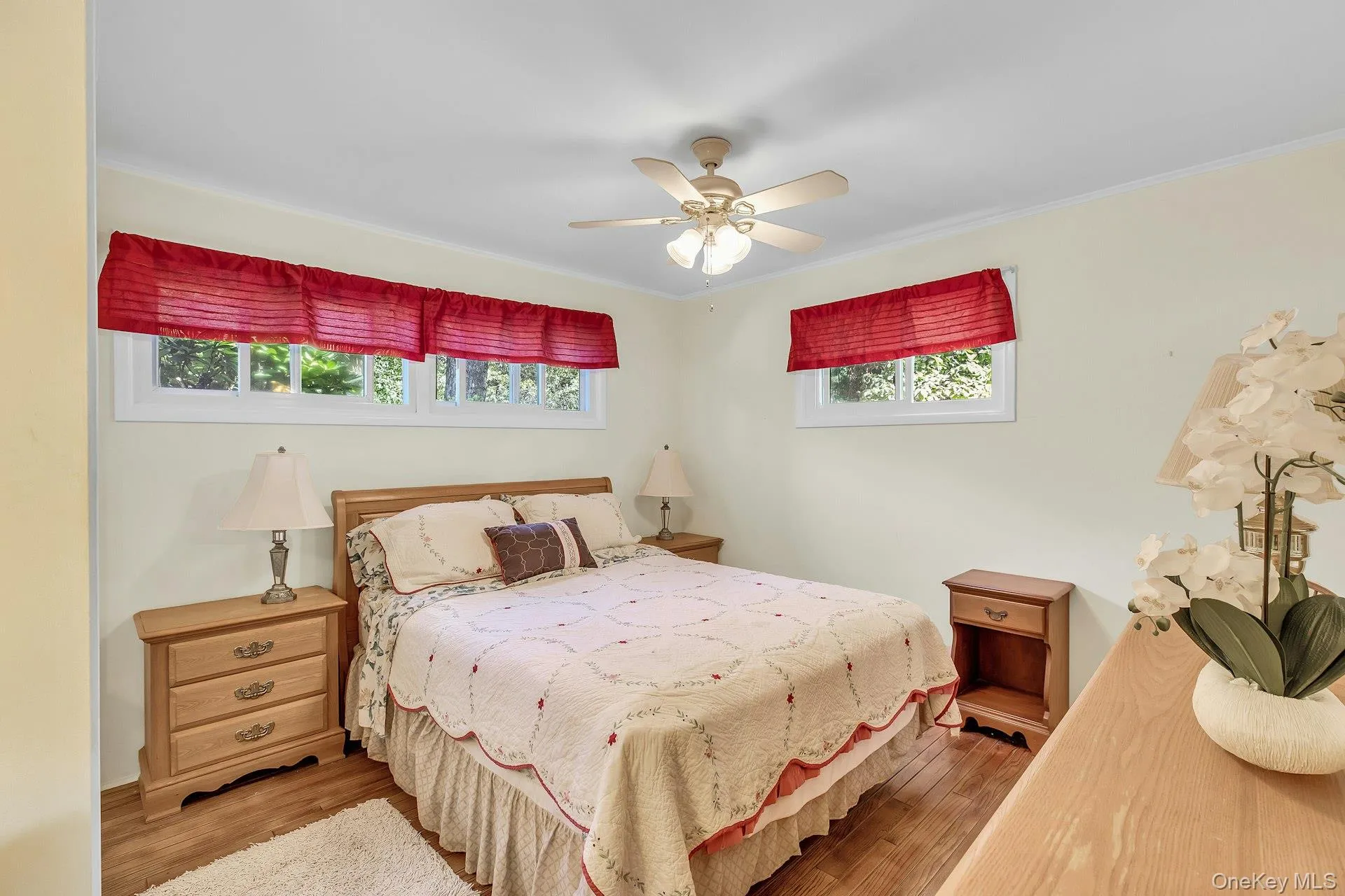 Recessed windows, wood-finish flooring, and a ceiling fan with integrated lighting Recessed windows, wood-finish flooring, and a ceiling fan with integrated lighting
