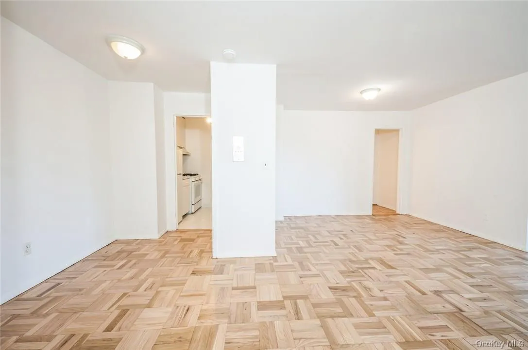 Foyer with entrance to kitchen and alcove with entrance to more closet space and bathroom Foyer with entrance to kitchen and alcove with entrance to more closet space and bathroom
