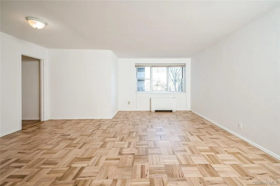 View of living room and sleeping alcove, flooded with lots of natural light, entrance to more closets & bathroom View of living room and sleeping alcove, flooded with lots of natural light, entrance to more closets & bathroom
