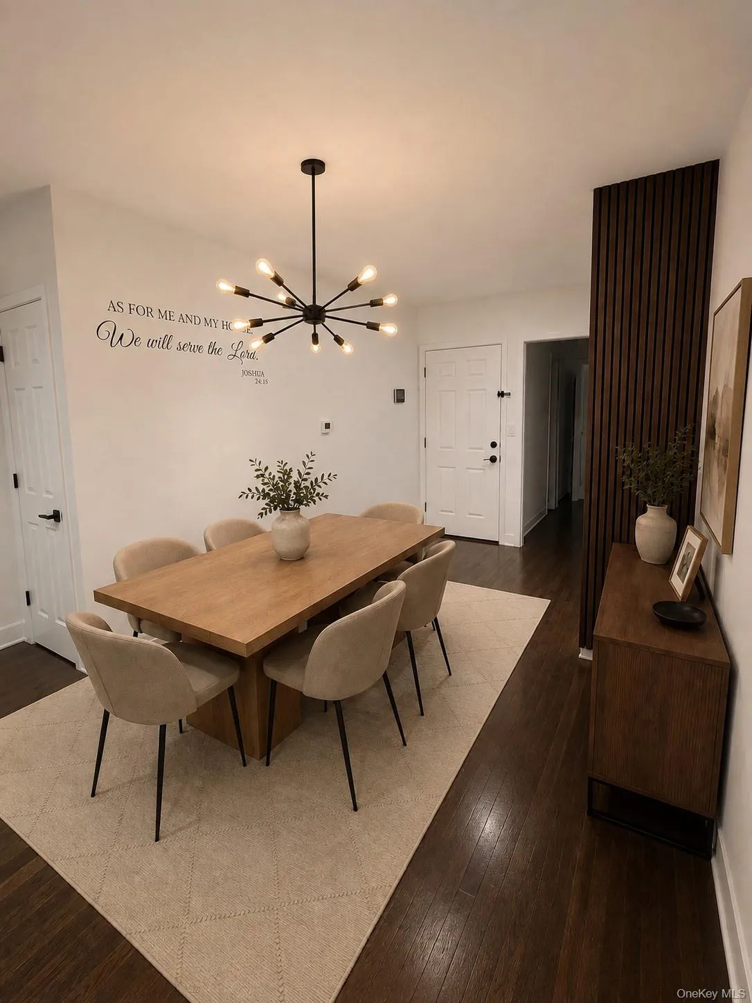Wood like flooring, contemporary sputnik chandelier, white paneled doors, and a decorative slatted wall accent Wood like flooring, contemporary sputnik chandelier, white paneled doors, and a decorative slatted wall accent
