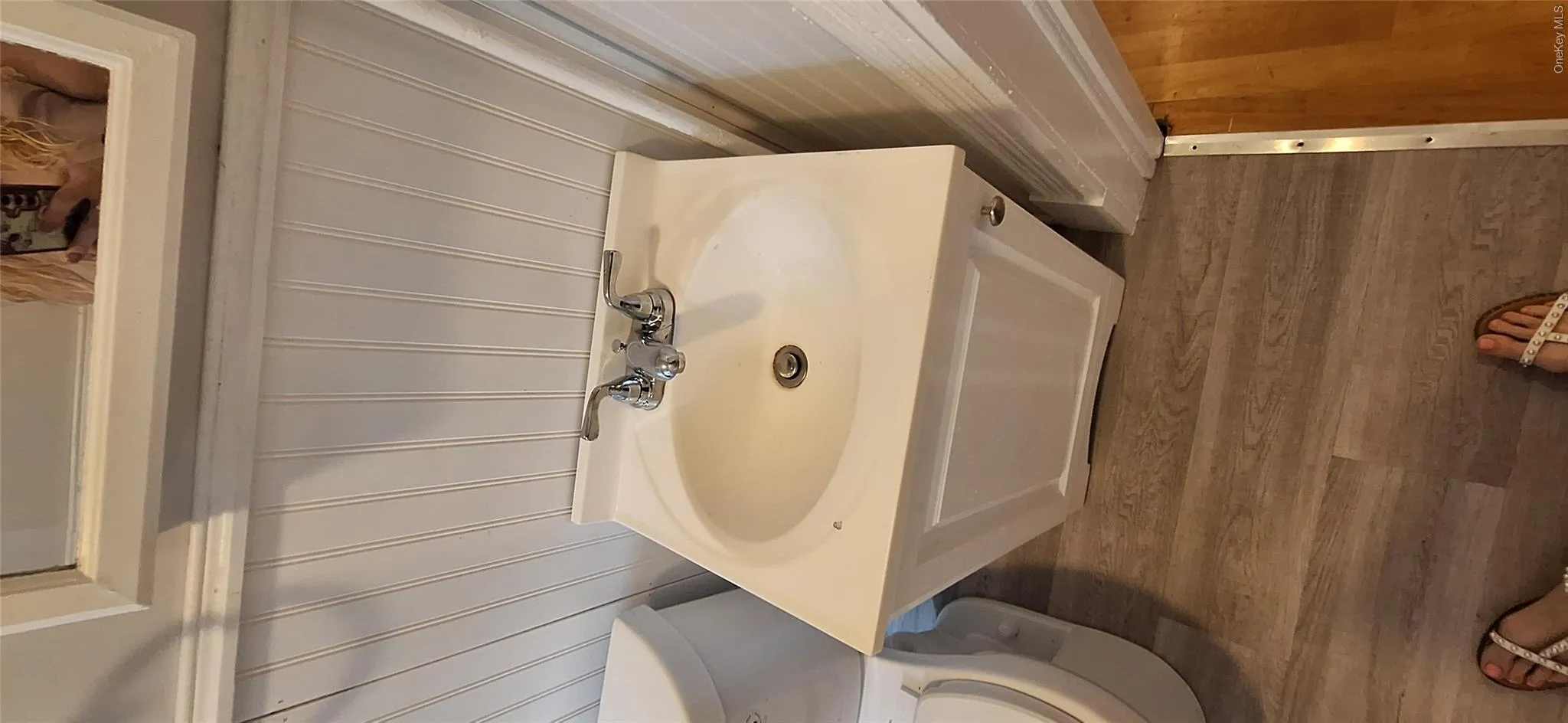 bath featuring wood finished floors and toilet bath featuring wood finished floors and toilet