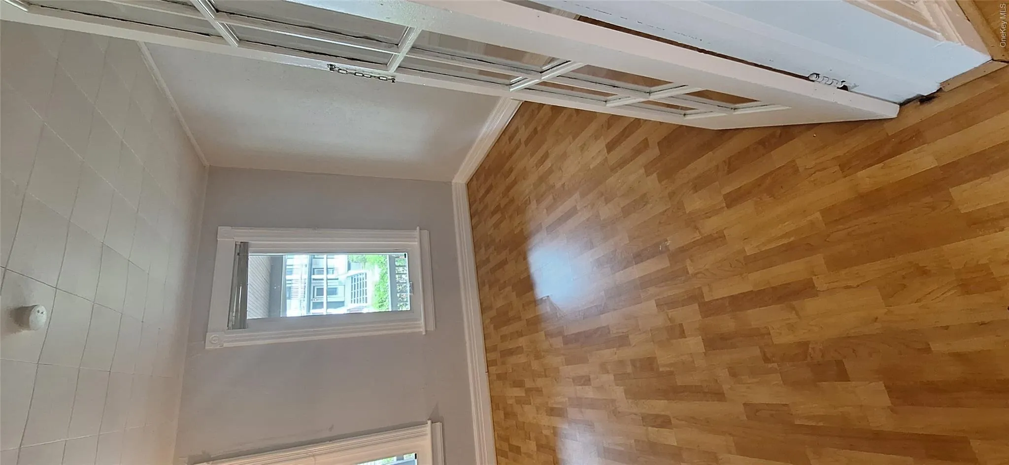 Bedroom featuring light oak laminate floors and baseboards Bedroom featuring light oak laminate floors and baseboards