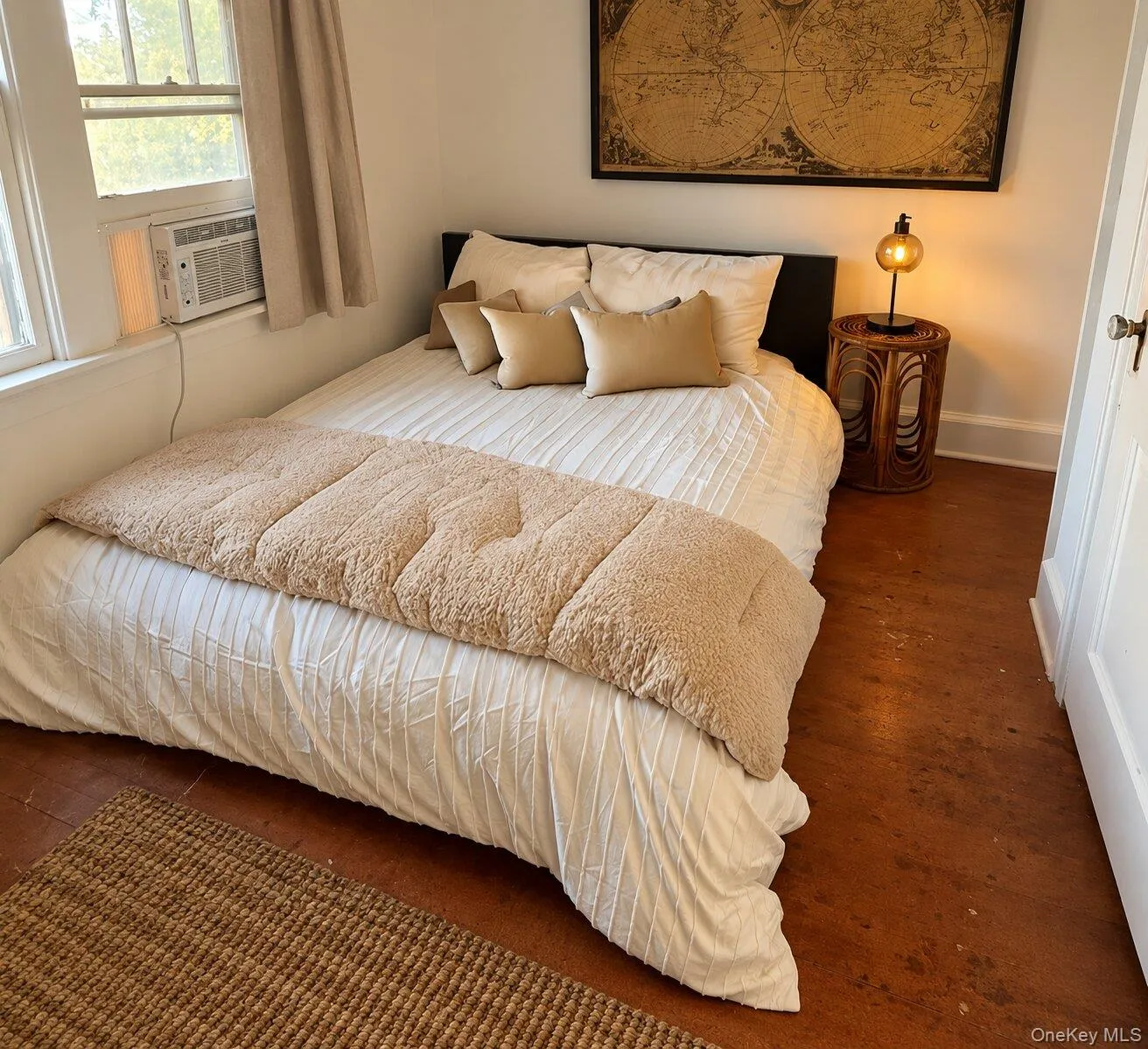Bedroom featuring hardwood / wood-style floors, vaulted ceiling, and multiple windows Bedroom featuring hardwood / wood-style floors, vaulted ceiling, and multiple windows