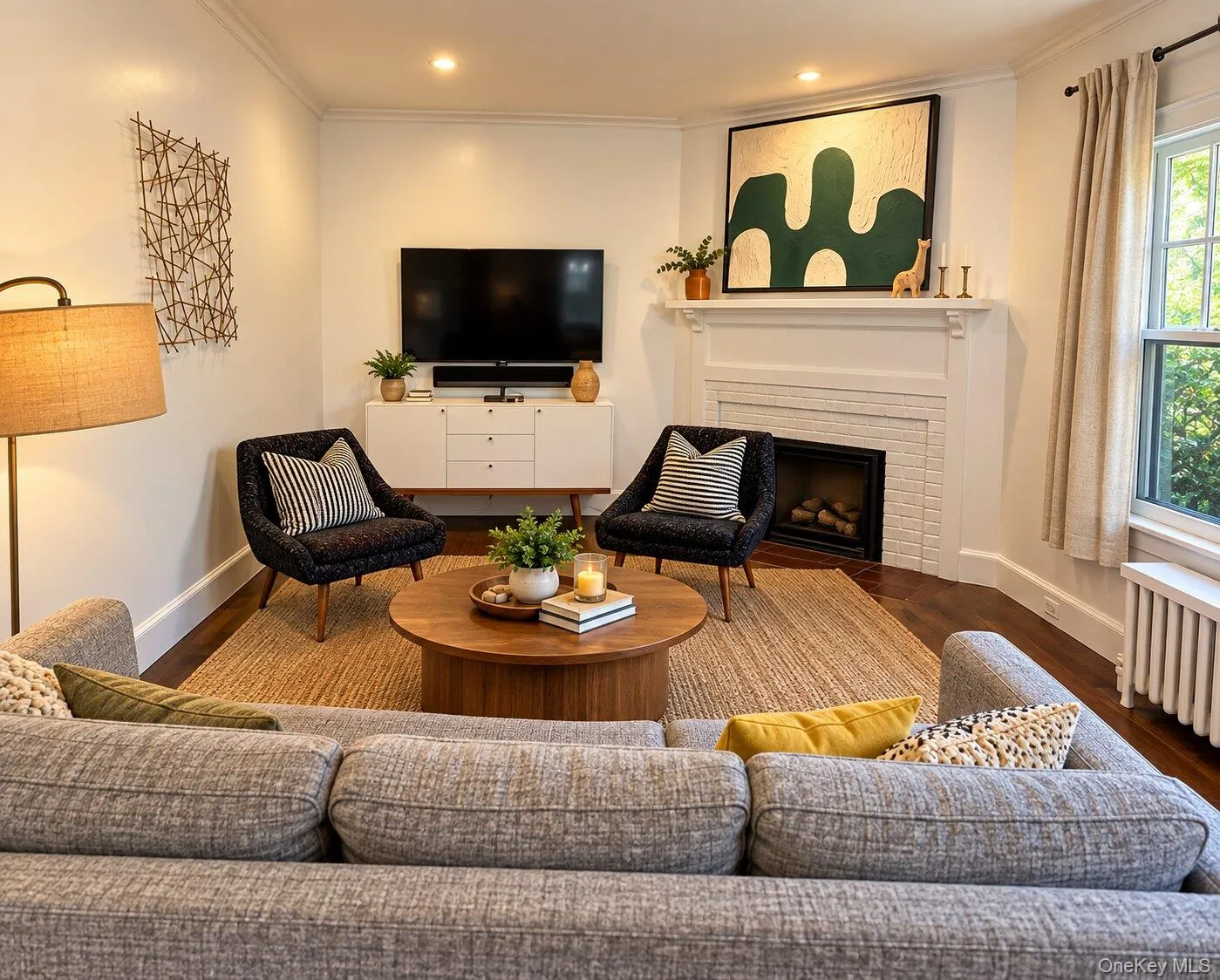 Virtually Staged. Living room featuring wood-type flooring and a brick fireplace Virtually Staged. Living room featuring wood-type flooring and a brick fireplace
