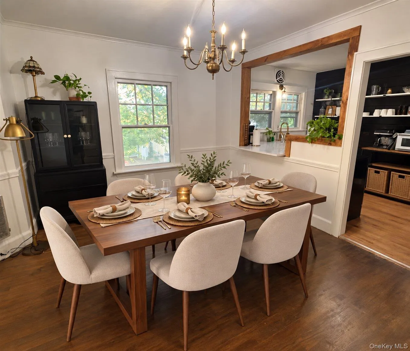 Virtually Staged. Dining room featuring an inviting chandelier, crown molding, and dark wood-type flooring Virtually Staged. Dining room featuring an inviting chandelier, crown molding, and dark wood-type flooring