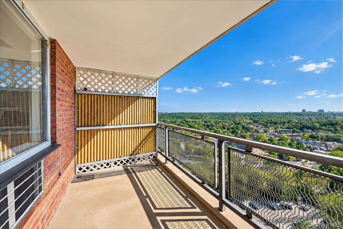 Private balcony with concrete flooring, brick exterior wall, and metal railings Private balcony with concrete flooring, brick exterior wall, and metal railings