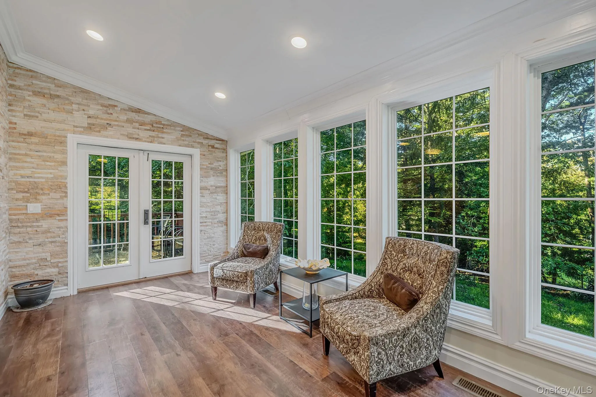 At the top of the stairs is this charming windor wrapped space with French doors to yard At the top of the stairs is this charming windor wrapped space with French doors to yard