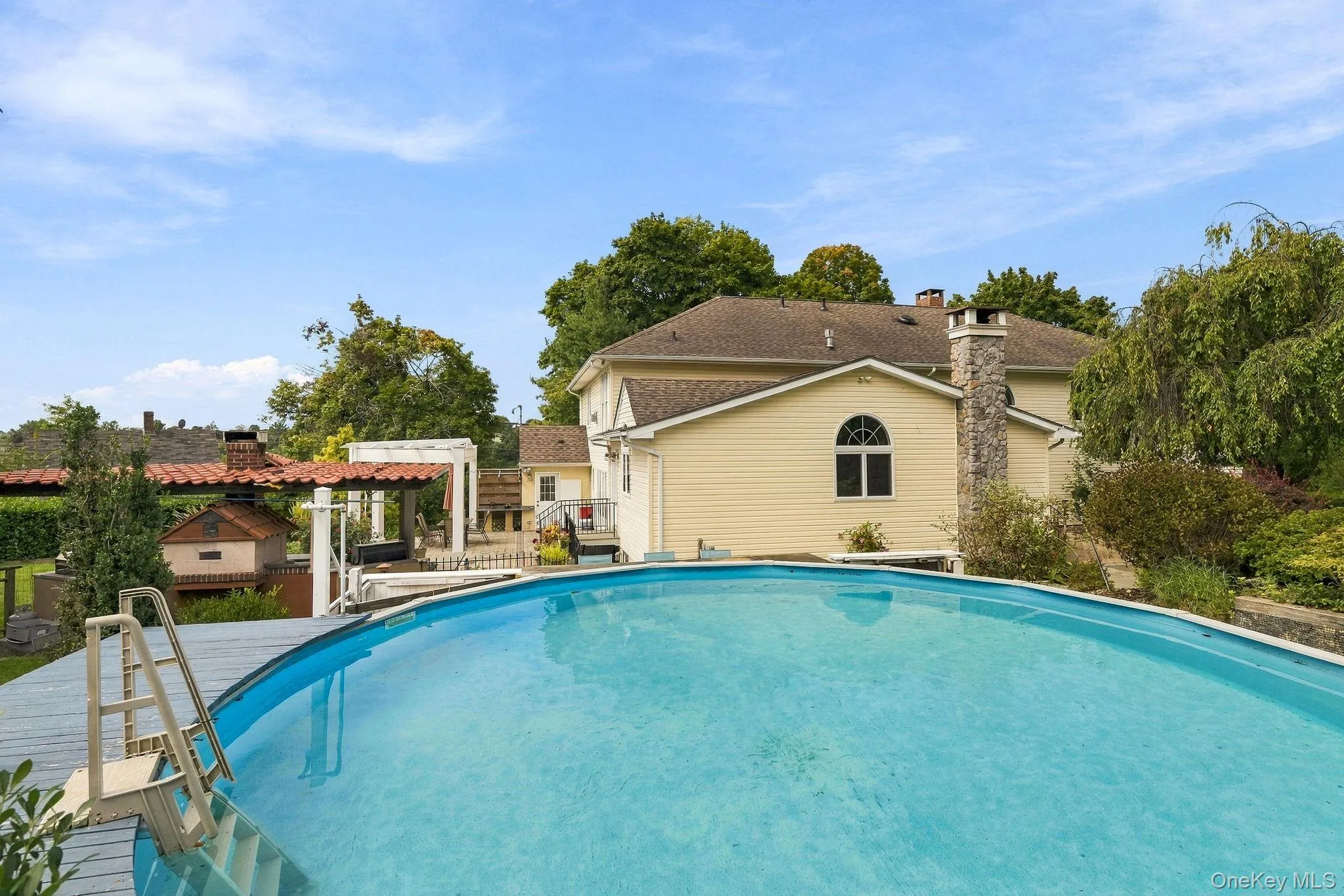 An above-ground pool and adjoining deck create a resort-like escape at home. An above-ground pool and adjoining deck create a resort-like escape at home.