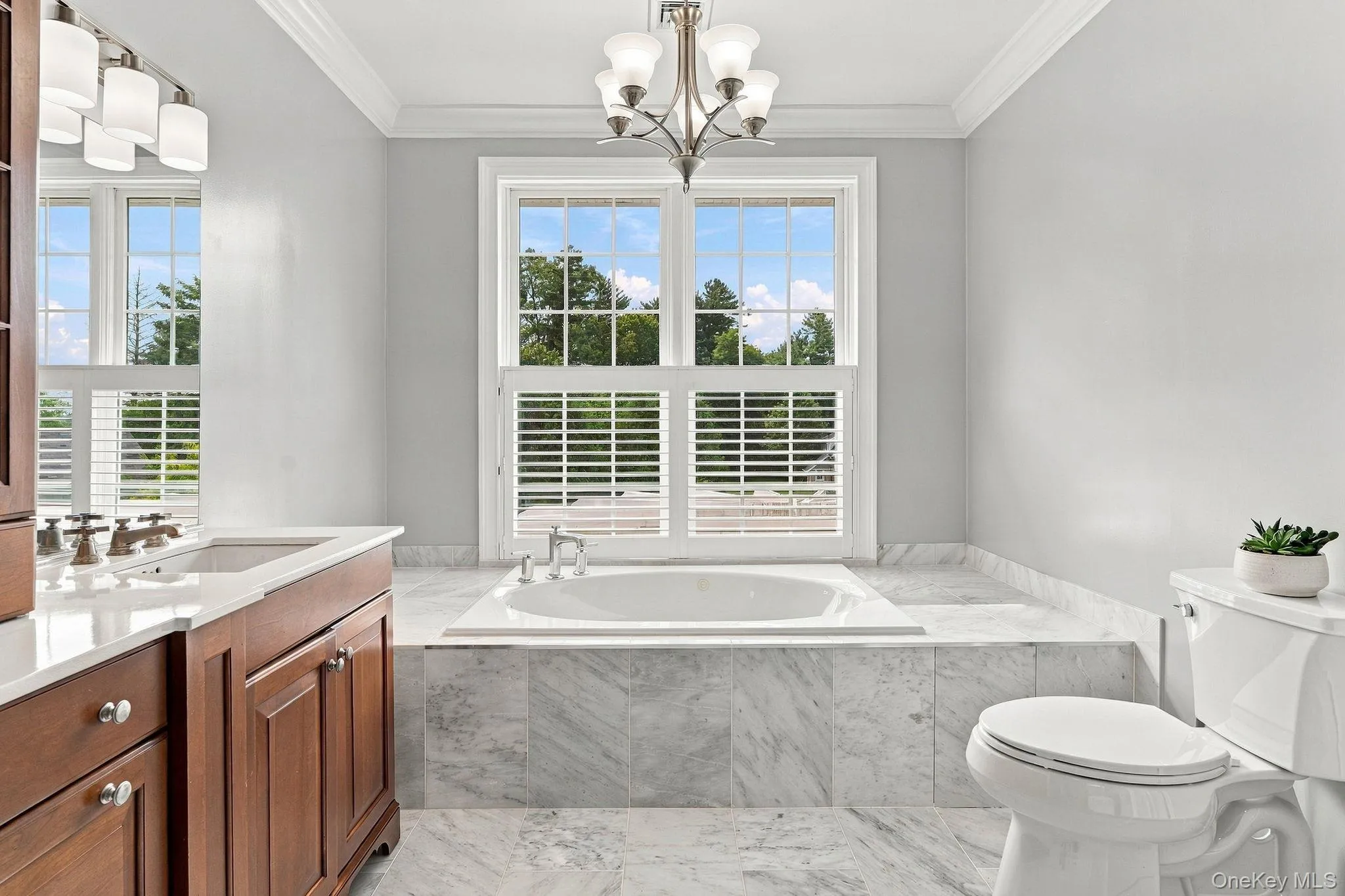 A beautifully appointed ensuite with marble finishes and an elegant soaking tub. A beautifully appointed ensuite with marble finishes and an elegant soaking tub.