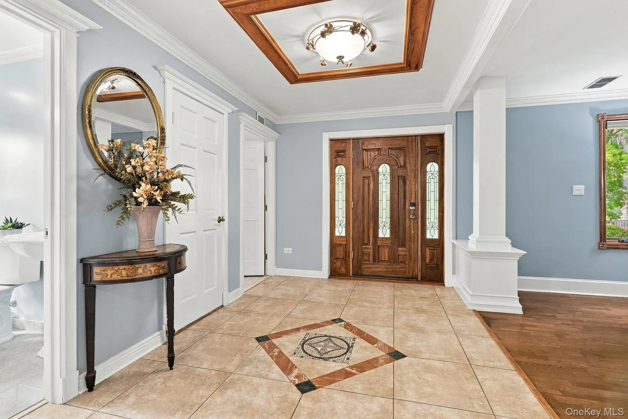 A grand introduction of hardwood floors, architectural columns and dentil molding. A grand introduction of hardwood floors, architectural columns and dentil molding.