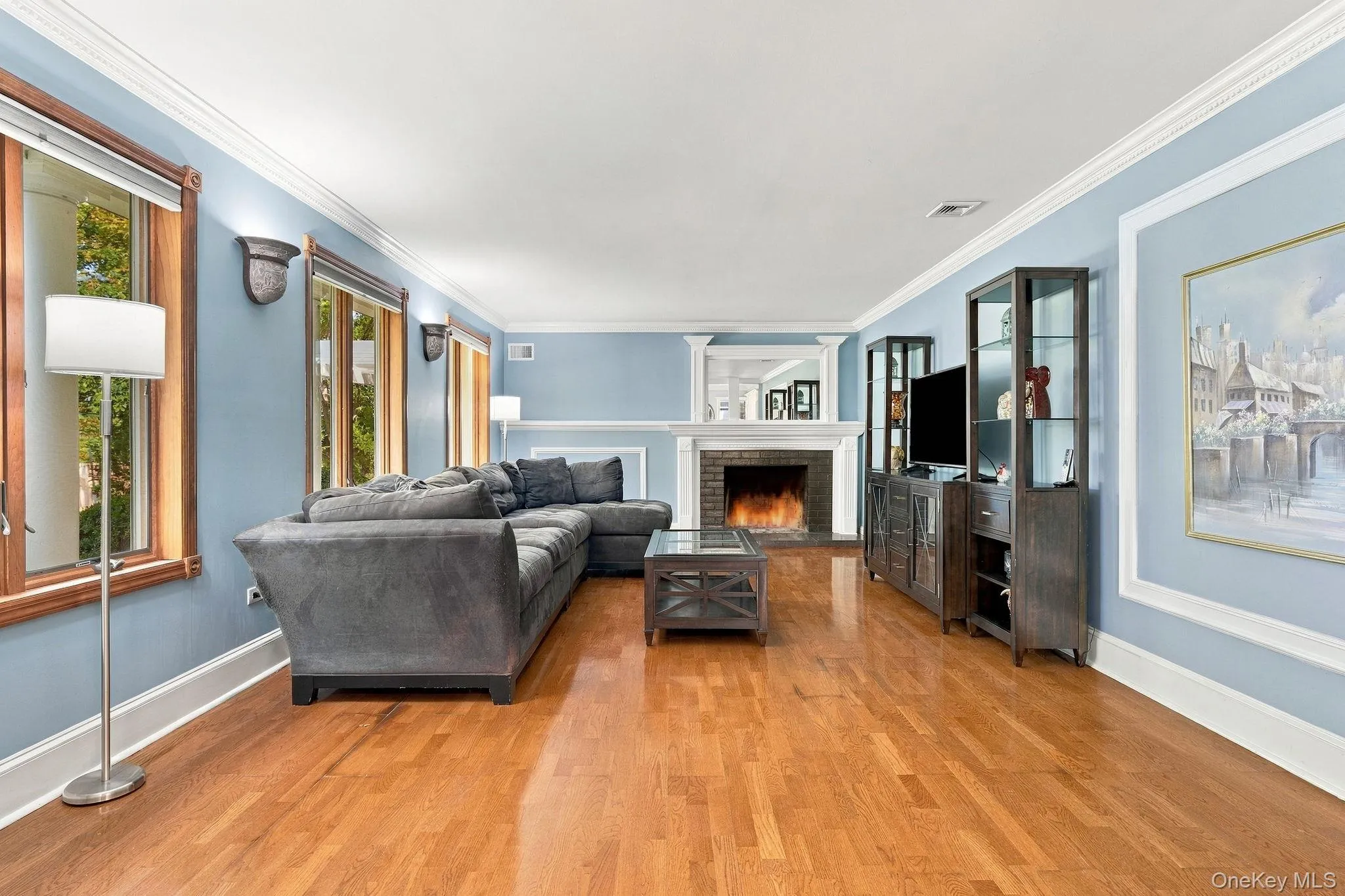 Architectural columns, rich hardwood floors and a handsome fireplace create timeless appeal. Architectural columns, rich hardwood floors and a handsome fireplace create timeless appeal.
