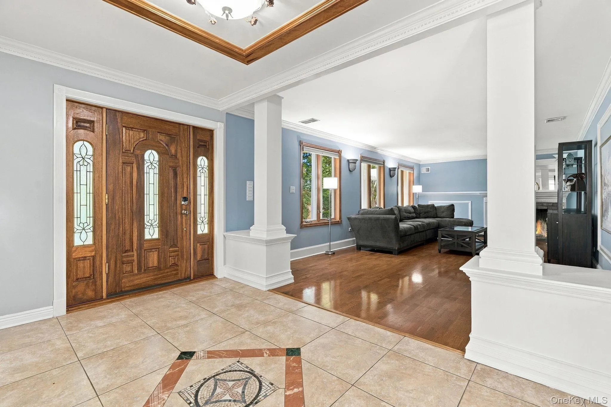 A custom-tiled foyer sets the tone with rich materials and refined architectural detail. A custom-tiled foyer sets the tone with rich materials and refined architectural detail.