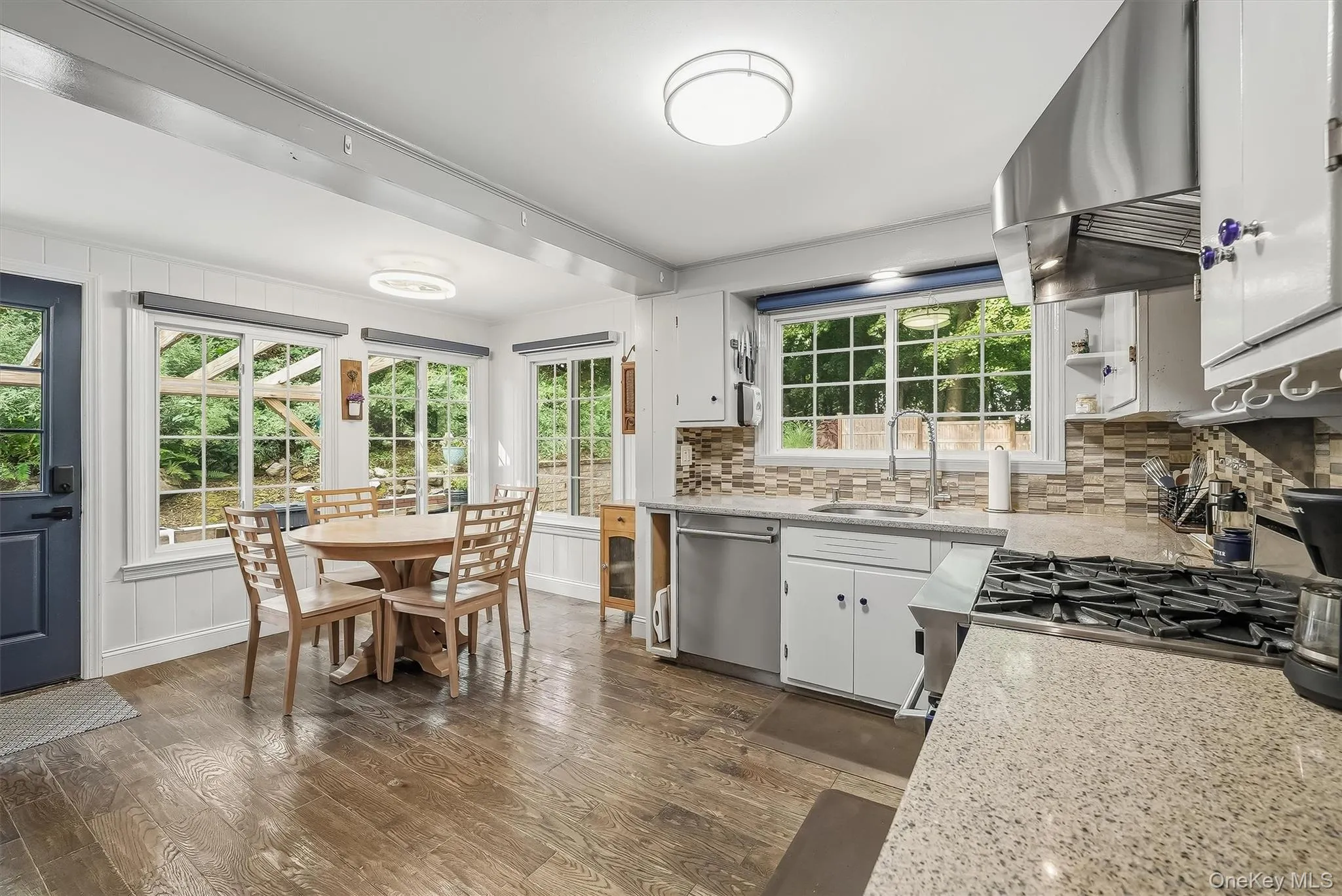 Large windows accent the gourmet kitchen and dining area filling the room with incredible natural sunlight. Large windows accent the gourmet kitchen and dining area filling the room with incredible natural sunlight.